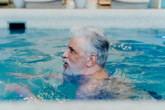 Hombre en la piscina practicando aquagym